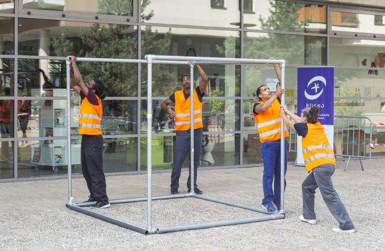 Danseur en gilet orange autour du module de dans Reicko à Villejuif Joseph dans le cadre du « chantier partagé » de la Société du Grand Paris